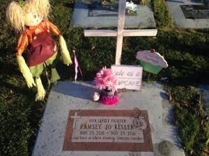 Headstone decorated with toys